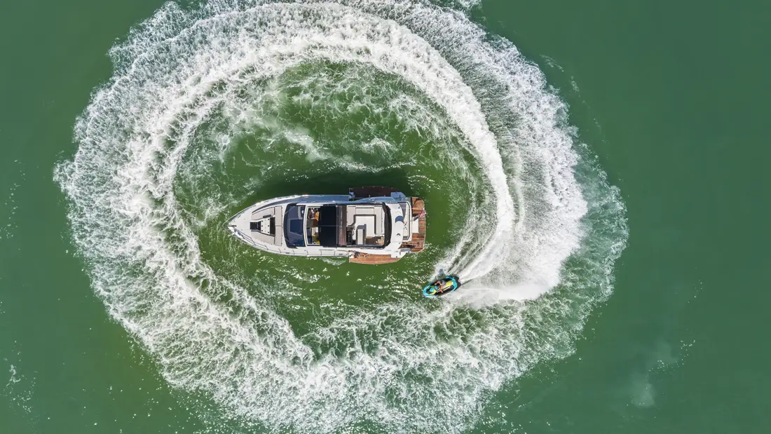 Overhead drone shot of the yacht carving a turn