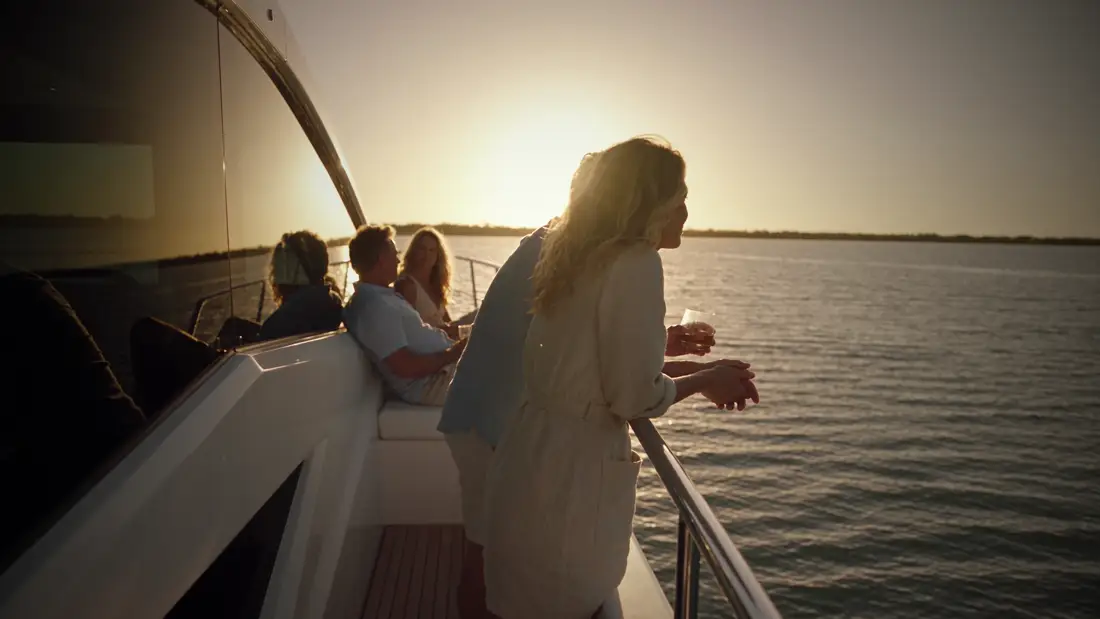 Guests at the rail at sunset